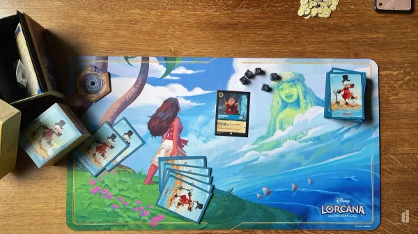 Disney Lorcana playmat with cards mid-game